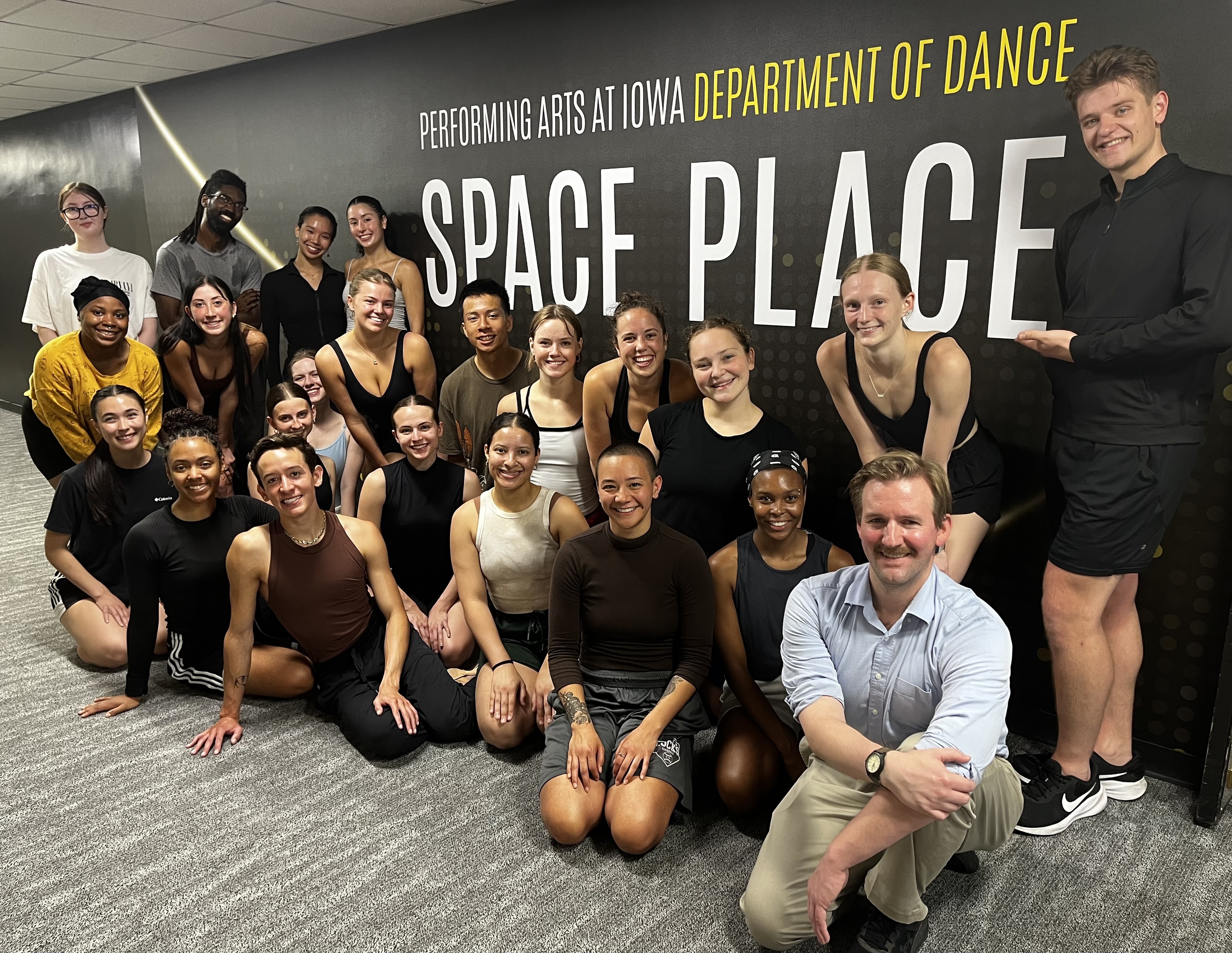 UI Dance and DanceWorks Chicago dancers posing smiling for a group photo in front of Space Place Theater