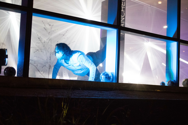 Dancer performing behind windows