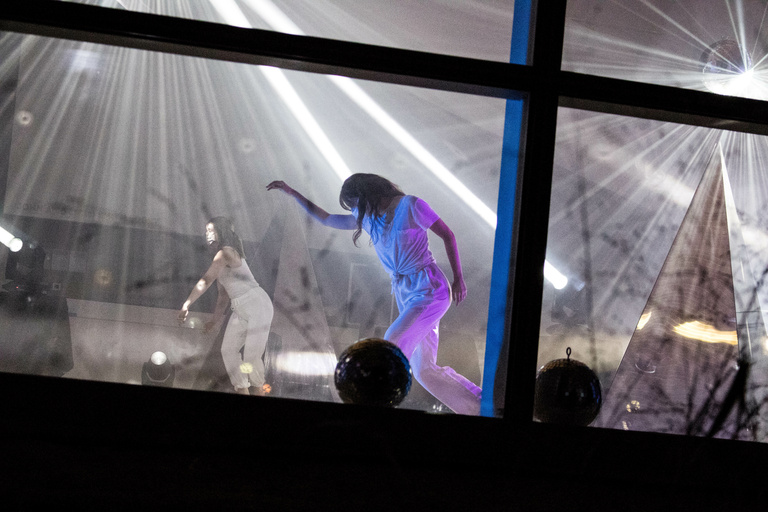 Dancer performing behind windows