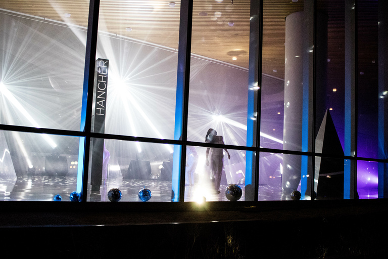 Dancer performing behind windows