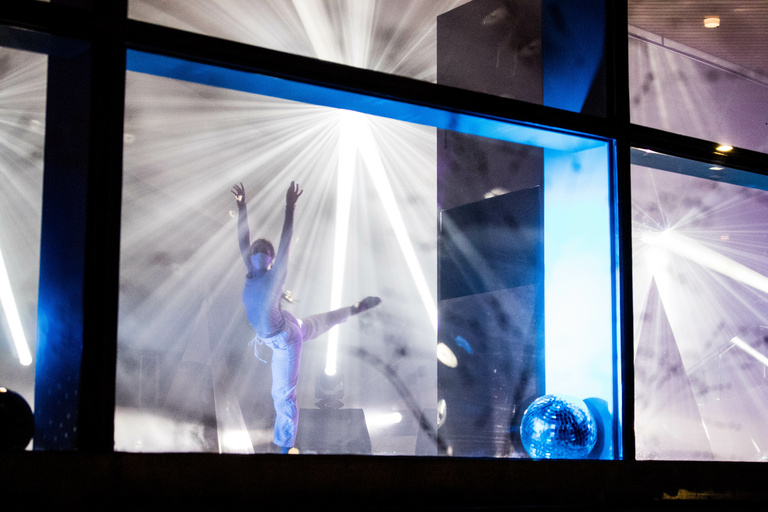 Dancer performing behind windows
