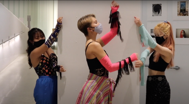 Three dancers in hallway