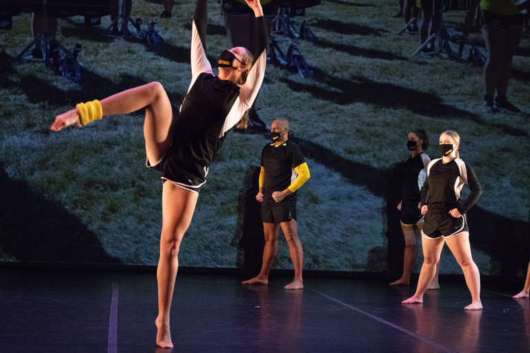 Dancer leaning back as others watch in the background