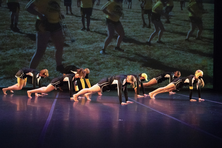 Group of dancers in a plank position