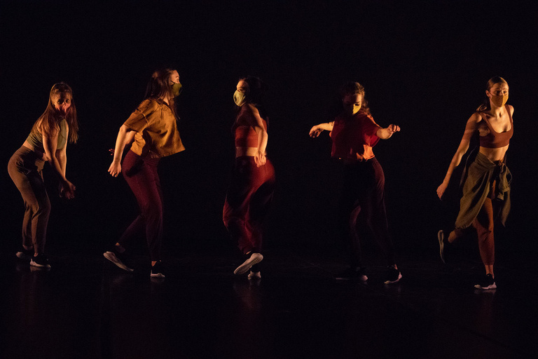 group of five dancers in performance