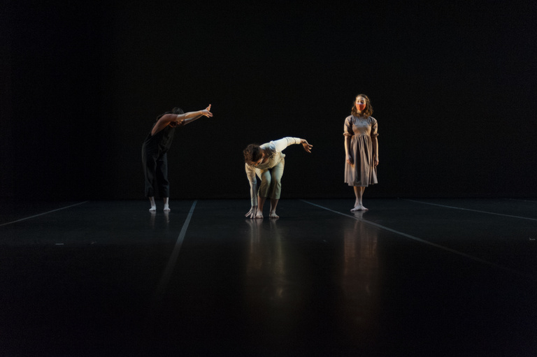 Three dancers performing on stage
