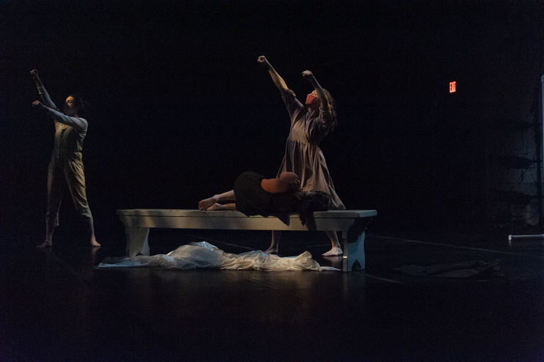 Three dancers performing on stage