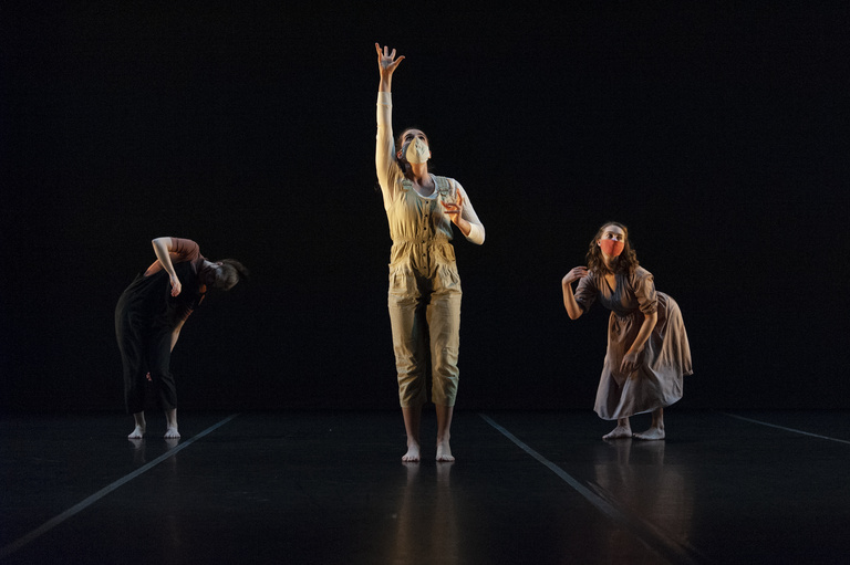 Three dancers performing on stage