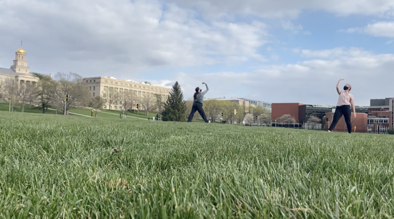 Dancers performing outside on the grass