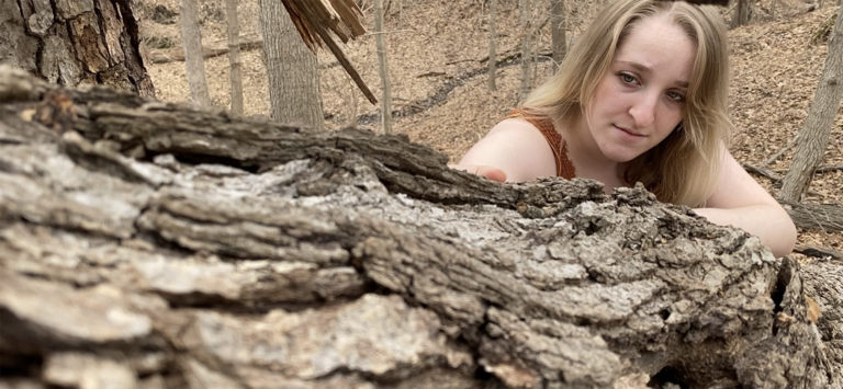 Dancer performing in a wooded area
