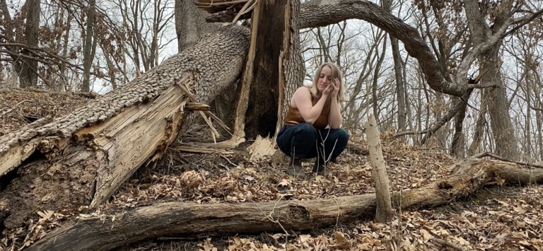 Dancer performing in a wooded area