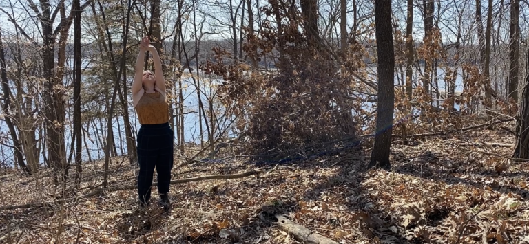 Dancer performing in a wooded area