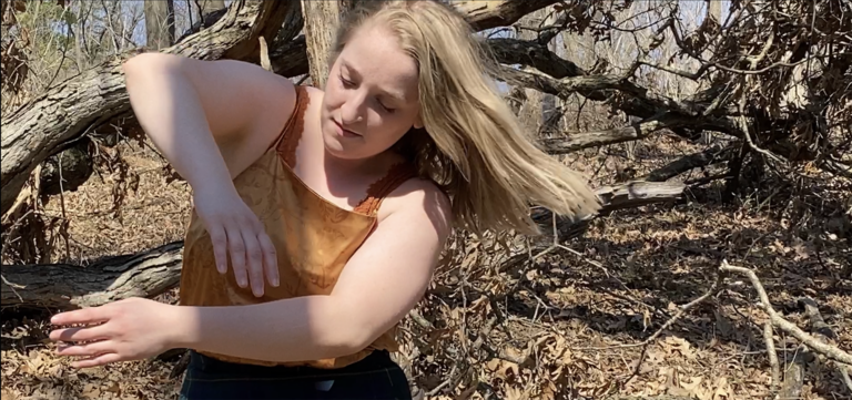 Dancer performing in a wooded area