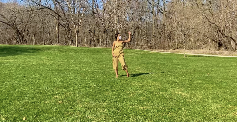 Dancer in performance in the middle of a lawn