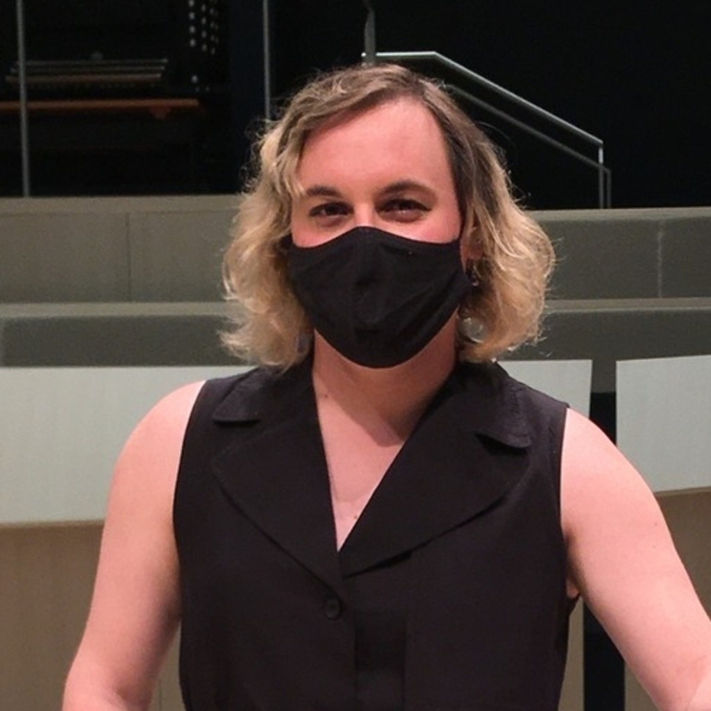 M Denney, wearing a mask