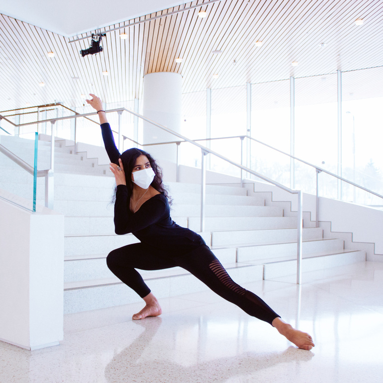 Dharmini Piekarska lunging in front of stairs