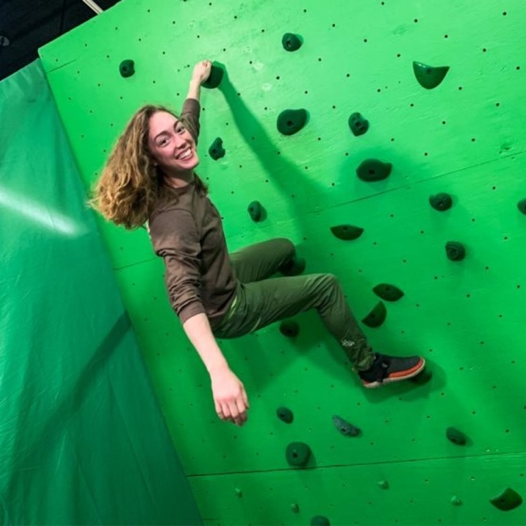 Ellen Oliver on a green screen rock wall