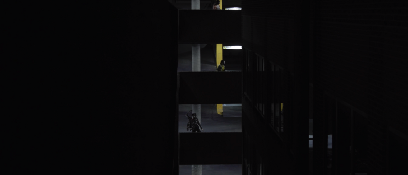 Dancers in a parking ramp at night