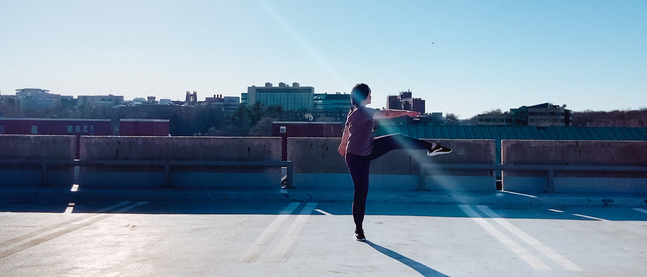 Allie Recht dancing on the top level of a parking ramp