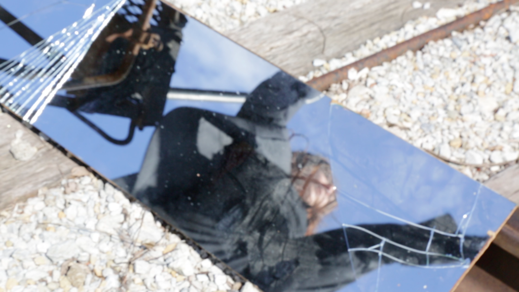Dancer Kate Vincek reflected in a piece of broken mirror