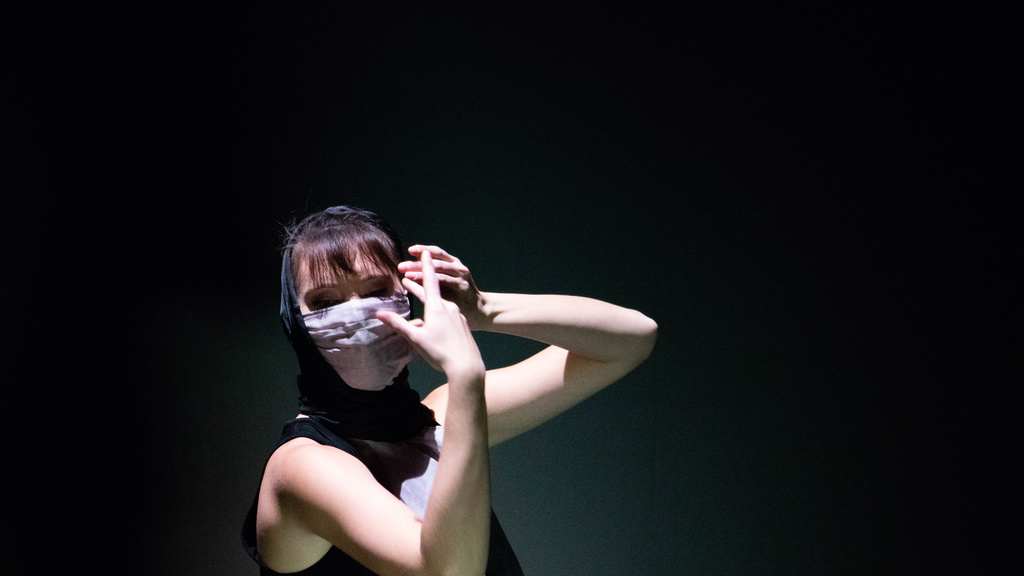 Close up of dancer wearing a face mask and a head scarf