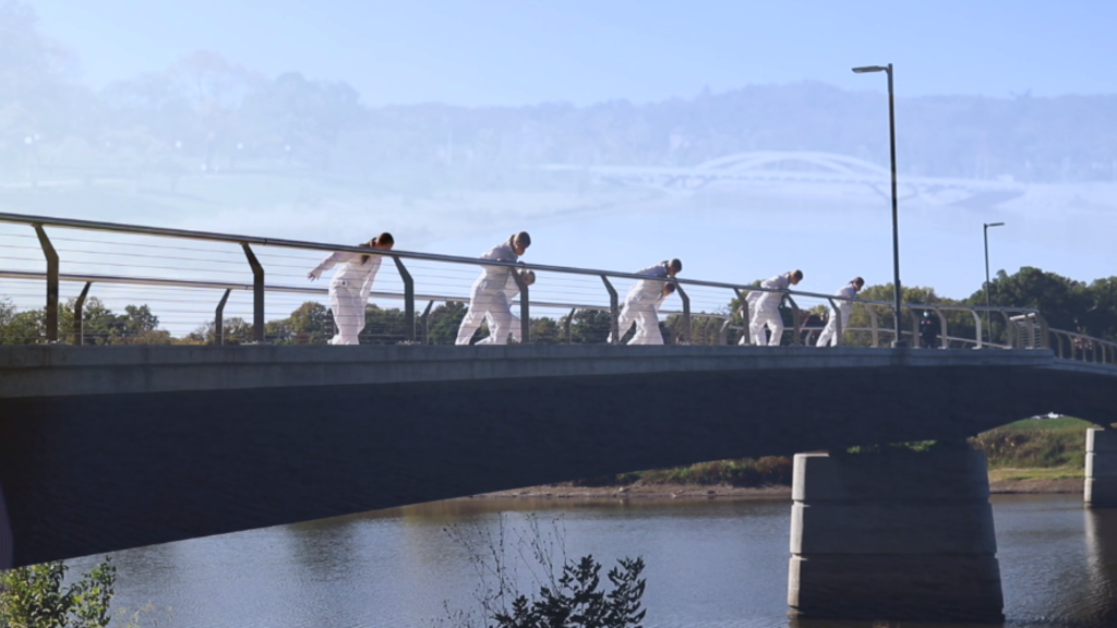 First-Year Seminar students dancing on bridge over the river