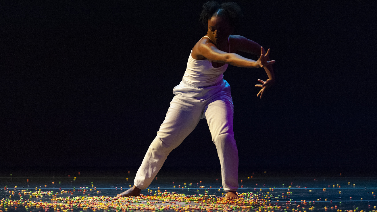 Dancer on stage, dancing on what appears to be Skittles