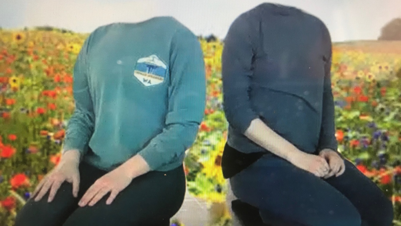 Two dancers kneeling in a green screen meadow without heads