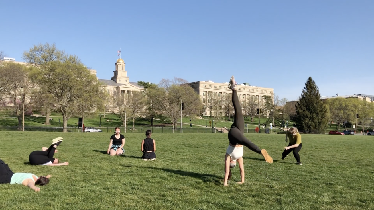 Dancers performing outside on the grass