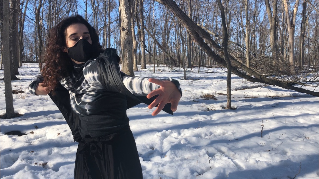 Dancer performing in the woods in the snow