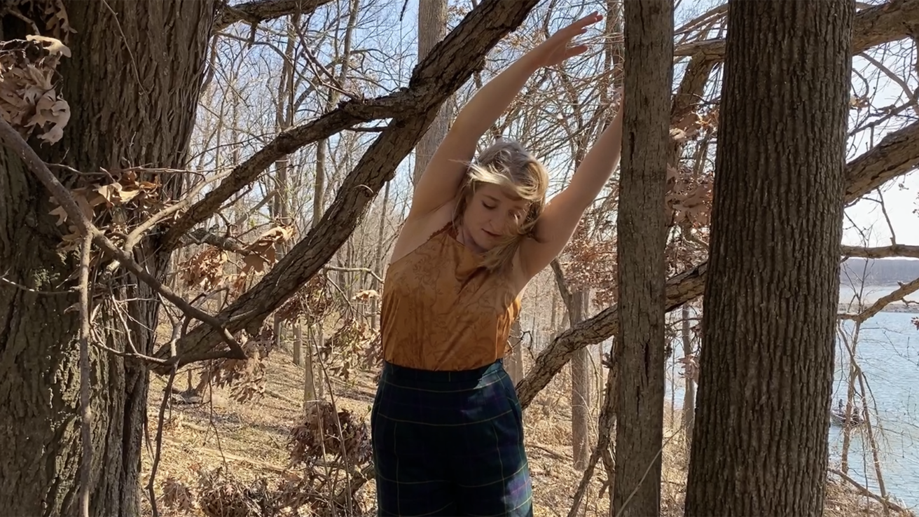 Dancer performing in the woods