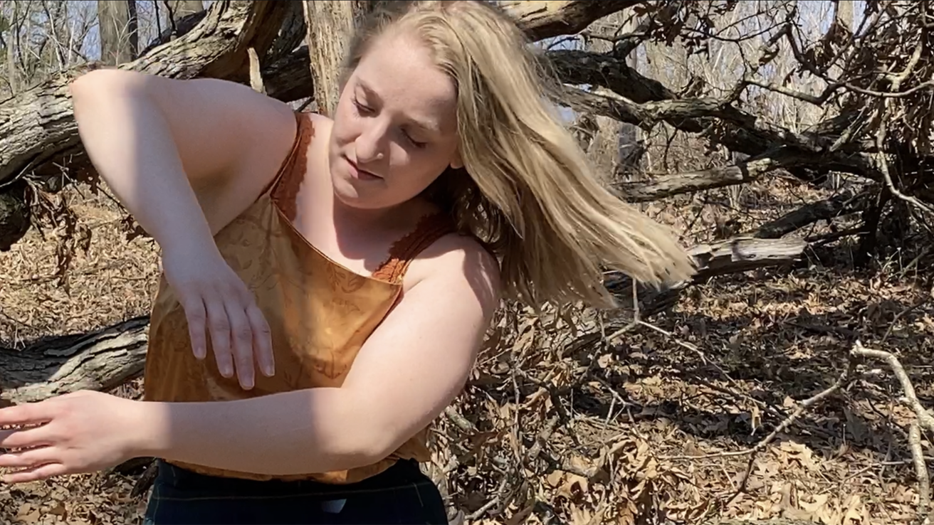 Dancer performing in a wooded area