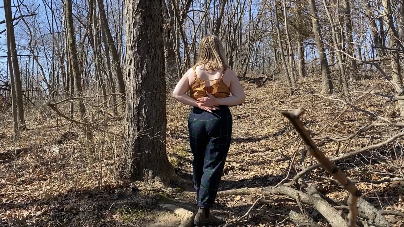 Dancer performing in a wooded area