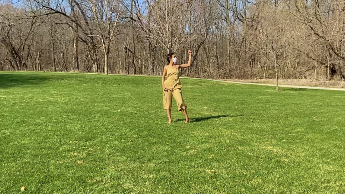 Dancer in performance in the middle of a lawn